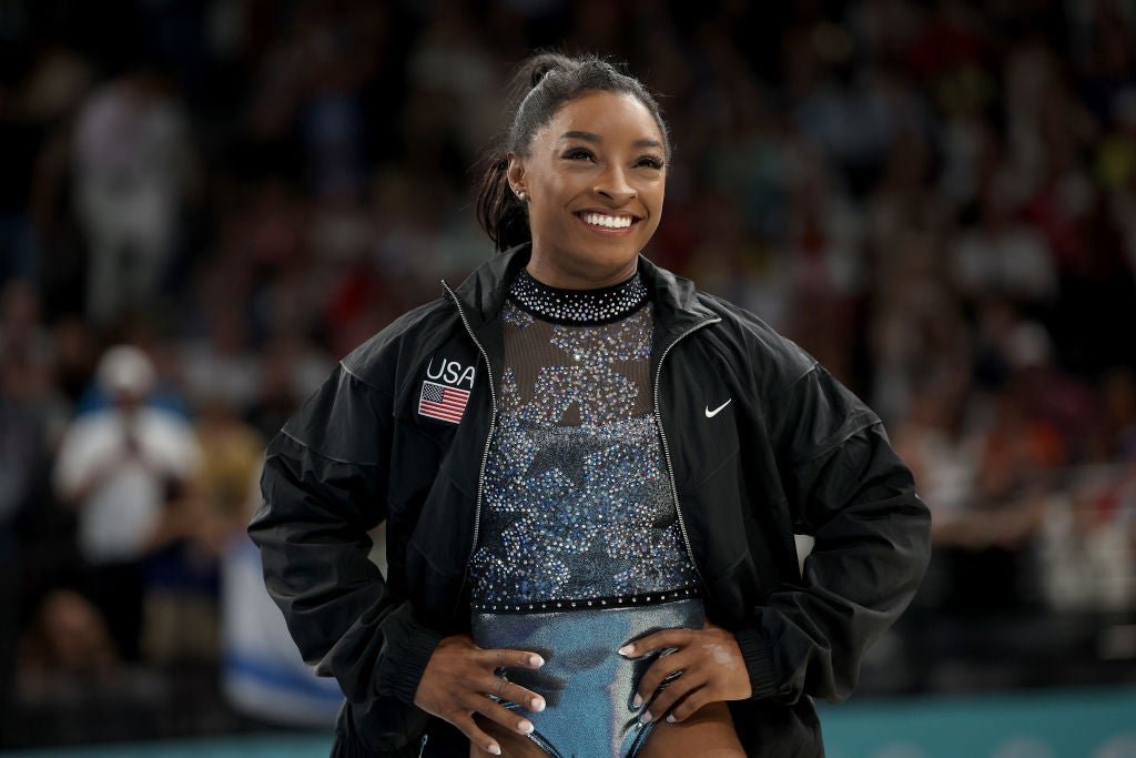 Simone Biles smiles as she arrives at graduation