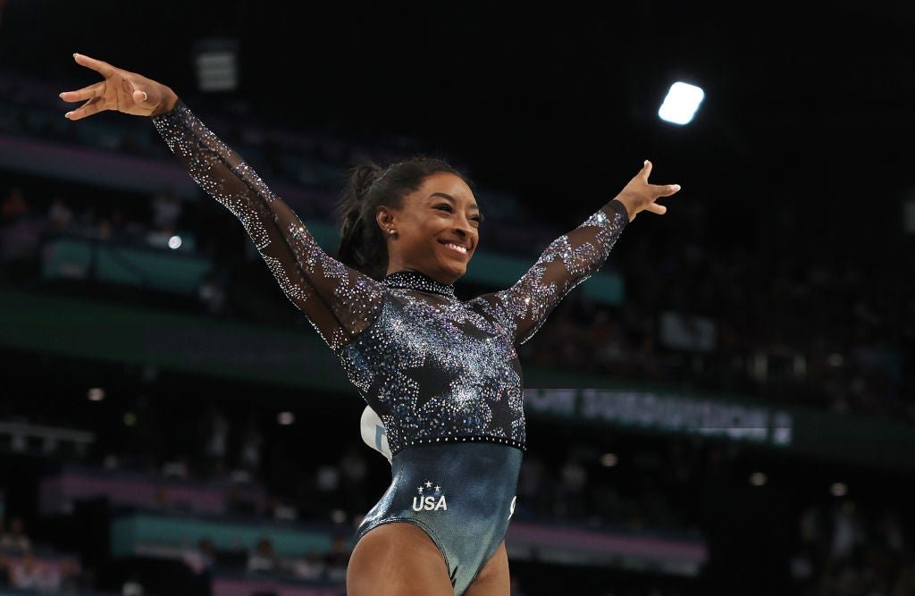 Simone Biles reacts after competing in the upper room